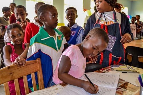 Signing their name in the attendance register at Phola hub