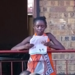 Sinethemba Nkosi reading in front of 1150 learners feat image